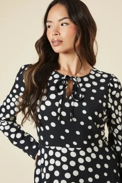 Black Spot tie front hanky hem dress